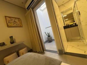 a room with a table and a glass door with a window at Tc Lofts in Uberlândia +122 photos