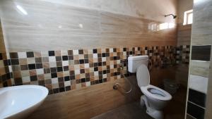 a bathroom with a toilet and a sink at BALAN INTERNATIONAL lodging in Chennai