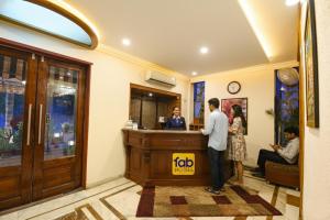 a man and a woman standing at a bar at FabHotel Siris 18 - Aravali Biodiversity Park in Gurgaon