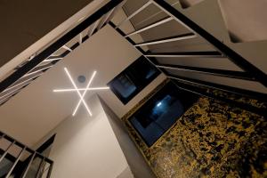 a staircase with a cross on the wall and a star on the ceiling at Hermoso LOFT en Guaduas in Guaduas