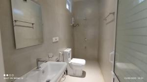 a bathroom with a sink and a toilet and a mirror at Blue Sky Villa 02 Ahangama in Ahangama