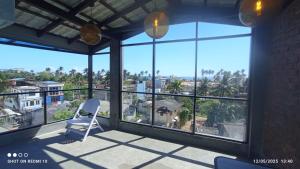 a chair on a balcony with a view of the city at Blue Sky Villa 02 Ahangama in Ahangama