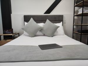 a laptop sitting on top of a bed with pillows at Nova Iorque Suites by Avia Suites in Bogotá
