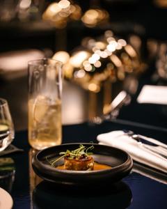 a plate of food on a table with a glass at HANNONG Hotel & Wine Bar in Strasbourg