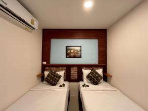 a room with two beds in a room at Sabai House in Phi Phi Islands +97 photos