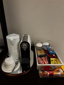 a coffee maker on a table with a tray of food at Guest room with private bathroom, WiFi, TV, Antwerp in Antwerp
