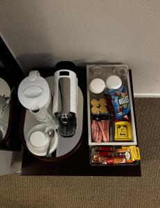 a table with a phone and some food on it at Guest room with private bathroom, WiFi, TV, Antwerp in Antwerp +2 photos