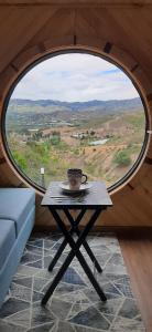 a coffee table in a room with a large window at Casa Villa de leyva in Sáchica