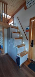 a staircase in a room with wooden ceilings at Casa Villa de leyva in Sáchica