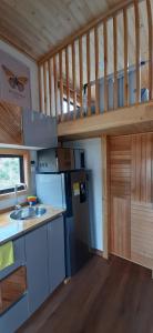 a kitchen in a tiny house with a staircase at Casa Villa de leyva in Sáchica +11 photos