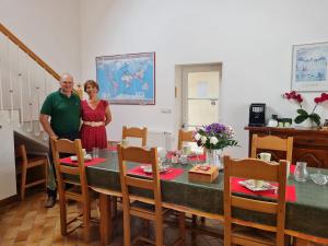 a man and a woman standing in front of a table at Chambre 1, Les Lilas in Cravant