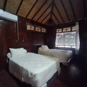 Ένα ή περισσότερα κρεβάτια σε δωμάτιο στο Gili Sudak Indah Paradise Beach Bungalow Bed & Breakfast