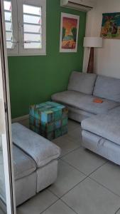 サント・リュスにあるSuperbe T3 avec une grande terrasse et un accès direct aux 2 plages Gros Raisinのリビングルーム(ソファ2台、ソファ1台付) +4枚の写真