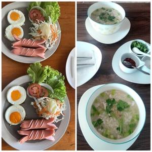 a table with plates of food and a bowl of soup at HOMEY-Sleepy Don Mueang Airport Hostel in Bangkok