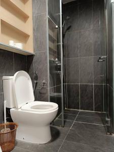 a bathroom with a toilet and a glass shower at The Luxe KLCC by Infinitum in Kuala Lumpur