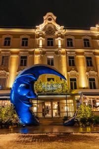 a large blue sculpture in front of a building at Radisson Collection Astorija Hotel, Vilnius in Vilnius