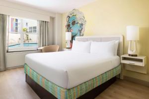 a bedroom with a large white bed and a window at Hotel Continental Miami Beach, Tapestry Collection by Hilton in Miami Beach