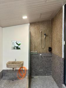 a bathroom with a shower and a sink at Ardour Lodge "B" Wing in George Town