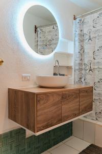 a bathroom with a sink and a mirror at Gaestehaus ESSENCE 