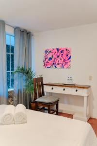 a bedroom with a desk and a table and a chair at Gaestehaus ESSENCE 