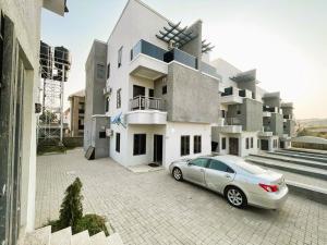 een auto geparkeerd voor een gebouw bij Mikuch Apartments and Suites in Abuja