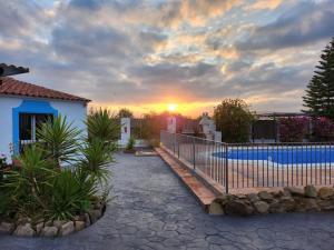 a house with a fence next to a swimming pool at Villa Mika in Alora