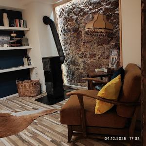 a living room with a chair and a wood stove at Ferien im Kayserreich in Reichelsheim