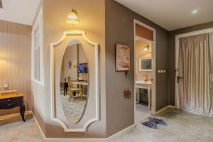 a hallway with a large mirror on the wall at Perennial Resort in Nai Yang Beach