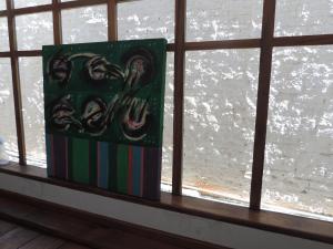 a book sitting on a window sill with a view of the water at Pousada Melhor Hora in Cunha