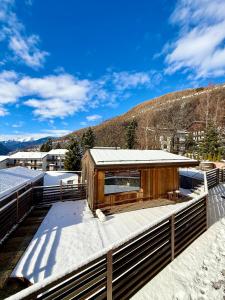a house on a roof with snow on the ground at Mulini 22 - Eco Suite & Spa in Temù