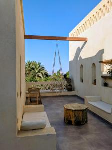 a balcony of a house with a table and a bench at The Roof by Barefoot in Tunis in Tunis +13 photos