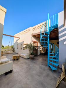 a blue spiral staircase in a living room of a house at The Roof by Barefoot in Tunis in Tunis