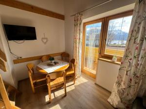 a small dining room with a table and a window at Haus Imbachhorn Summer Card included in Zell am See
