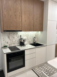 a kitchen with a sink and a stove at Elite Suite in Xanthi