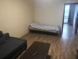 a small living room with a bed and a couch at Panorama flat in Sliven