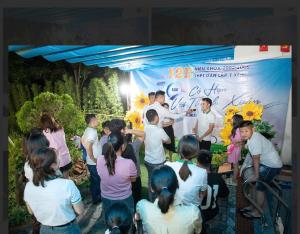 a group of people standing in front of a banner at Tràng An ChiDu Homestay in Ninh Binh