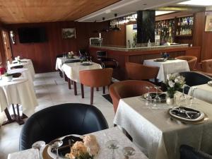 a restaurant with tables and chairs with white table cloth at Résidences hôtelières Micheline et Emile BASTOS in Yaoundé