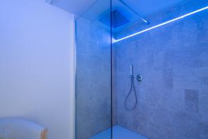 a bathroom with a shower with a glass door at Agriturismo Le Casaline in Seggiano +76 photos