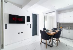 a kitchen and dining room with a table and chairs at Villa Melora in Pitsidia
