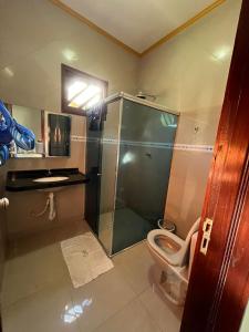 un bagno con doccia, WC e lavandino di Chácara com piscina e 3 varandas no Caldas a Barbalha Altre 8 foto