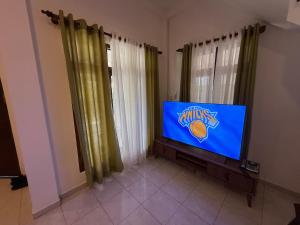 a flat screen tv sitting in a living room at Ceylon Villa in Matara