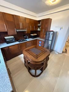 a kitchen with a wooden table and a refrigerator at Ceylon Villa in Matara +10 photos