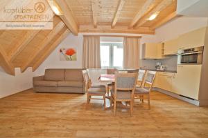 a kitchen and dining room with a table and chairs at Alpenperle in Ischgl