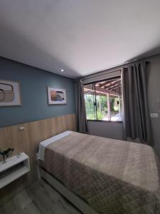 Ένα ή περισσότερα κρεβάτια σε δωμάτιο στο Recanto Carvalho - Suíte 12