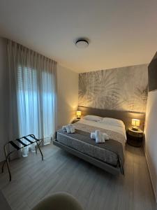 Ένα ή περισσότερα κρεβάτια σε δωμάτιο στο The Rooms Catanzaro Lido