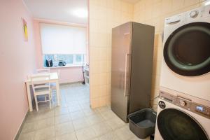 a kitchen with a washing machine in a room at I&A Residence Pirita314 in Tallinn