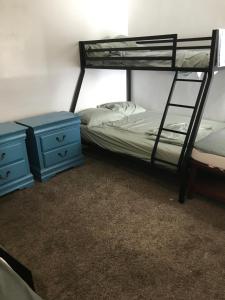 a bedroom with two bunk beds and two blue night stands at PalmBeachDowntownPrivatHouseShare99perpersonupto5Party in West Palm Beach