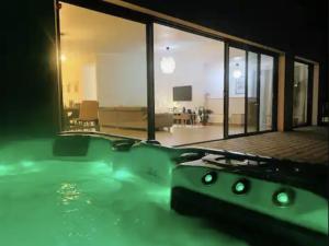 a swimming pool in a house with a living room at Villa Armor Vue mer et Spa in Carantec