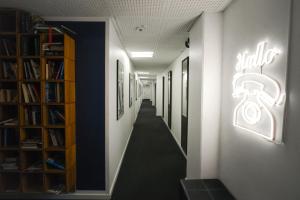 a hallway with a lighted sign on a wall at Danhostel Aarhus City in Aarhus