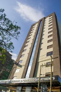 a tall building with a sign in front of it at Alya Hotel & Suites Ltd in Nairobi